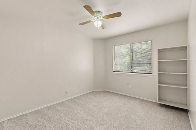 empty room featuring ceiling fan and light colored carpet