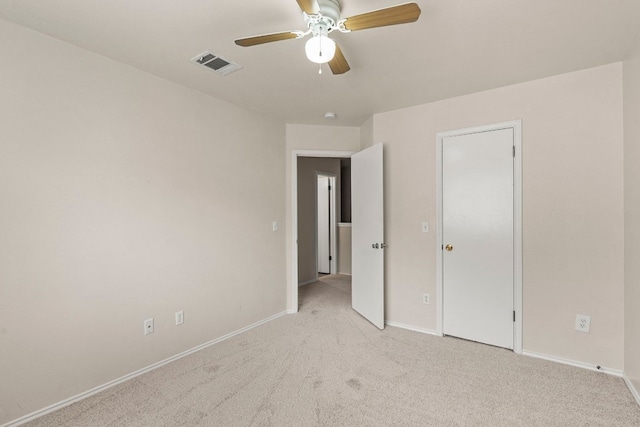 unfurnished bedroom featuring ceiling fan and light carpet