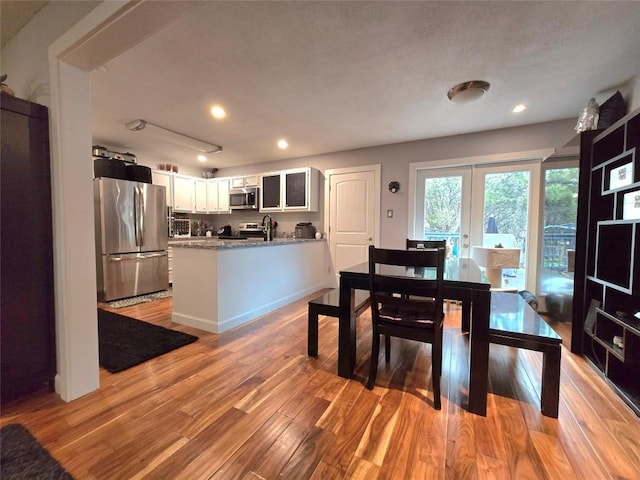 dining space featuring french doors and light hardwood / wood-style floors