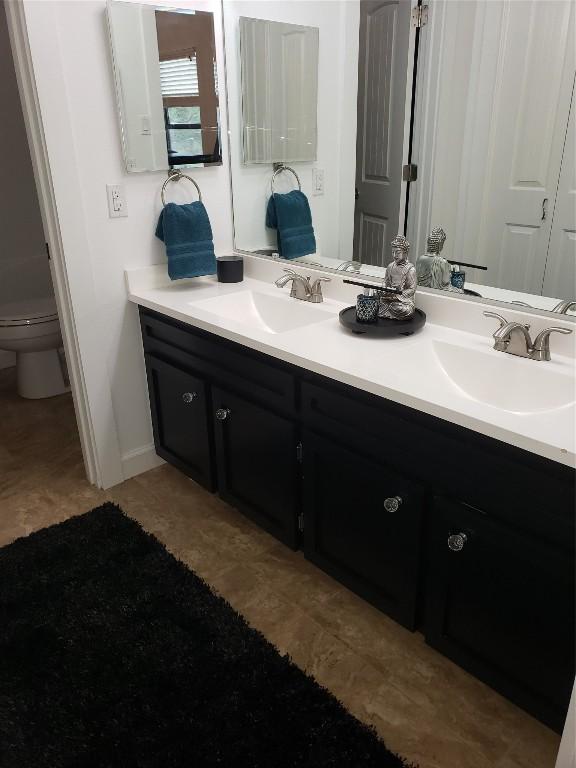 bathroom featuring vanity and toilet