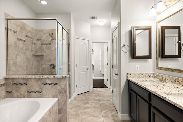 bathroom with tile patterned flooring, vanity, and independent shower and bath