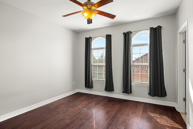 unfurnished room with ceiling fan and dark hardwood / wood-style floors