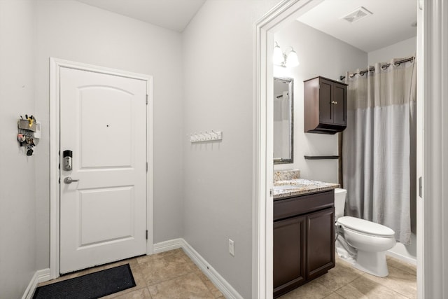 interior space featuring vanity, toilet, a shower with curtain, and tile patterned flooring