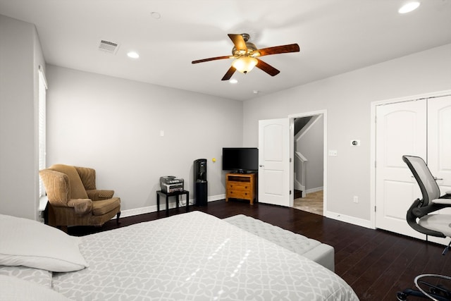 bedroom with a closet, ceiling fan, and dark hardwood / wood-style floors