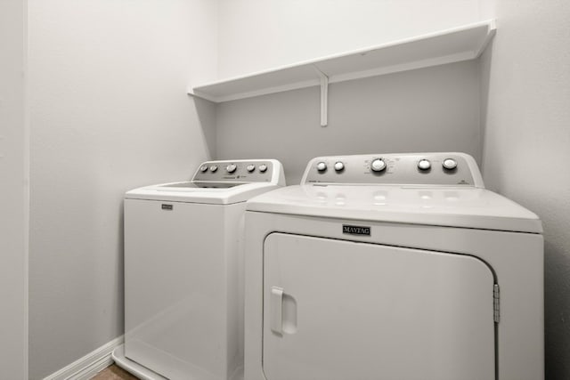 clothes washing area with washer and clothes dryer