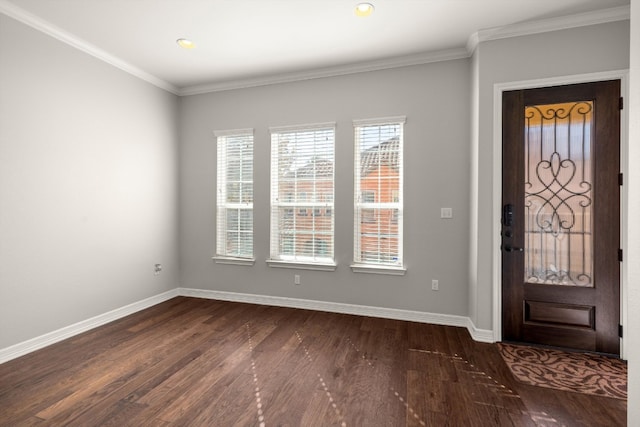 entrance foyer featuring dark wood-type flooring, a wealth of natural light, and crown molding