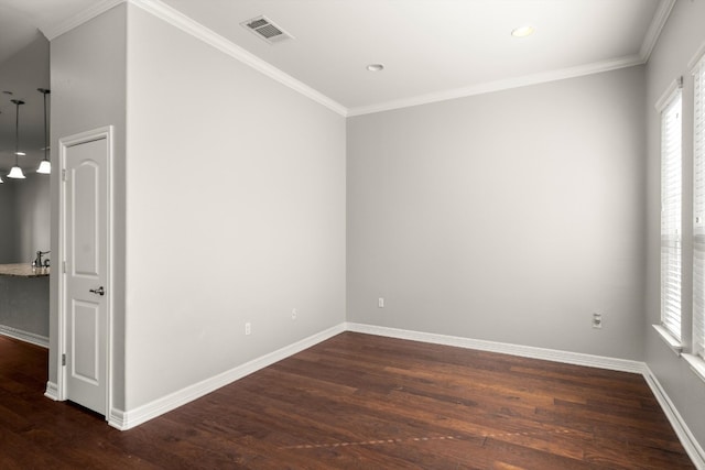 unfurnished room featuring crown molding, plenty of natural light, and dark wood-type flooring