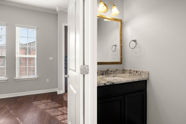 bathroom featuring crown molding, vanity, and wood-type flooring