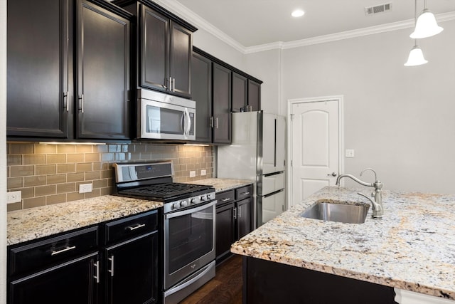 kitchen featuring decorative light fixtures, appliances with stainless steel finishes, light stone countertops, sink, and dark wood-type flooring