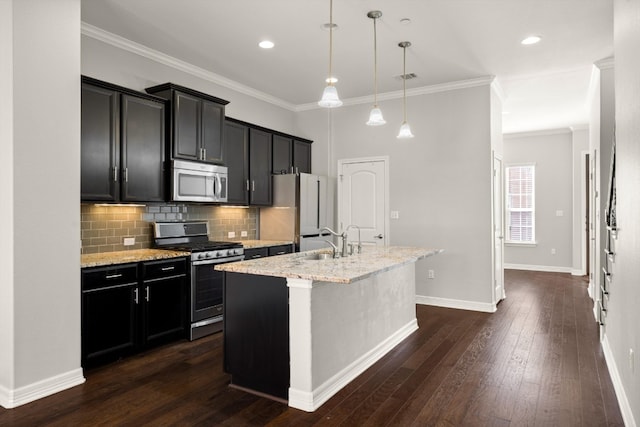 kitchen with light stone counters, stainless steel appliances, sink, dark hardwood / wood-style floors, and a center island with sink