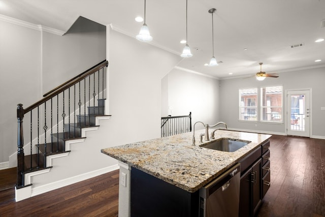 kitchen with dark wood-type flooring, light stone counters, stainless steel dishwasher, and sink