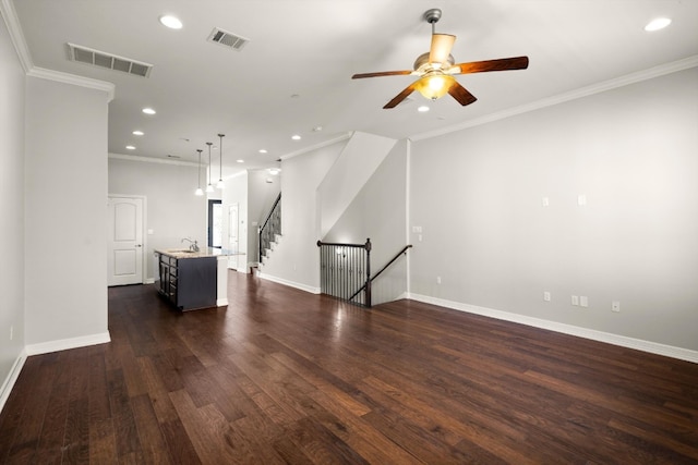 spare room featuring ceiling fan, dark hardwood / wood-style floors, and crown molding