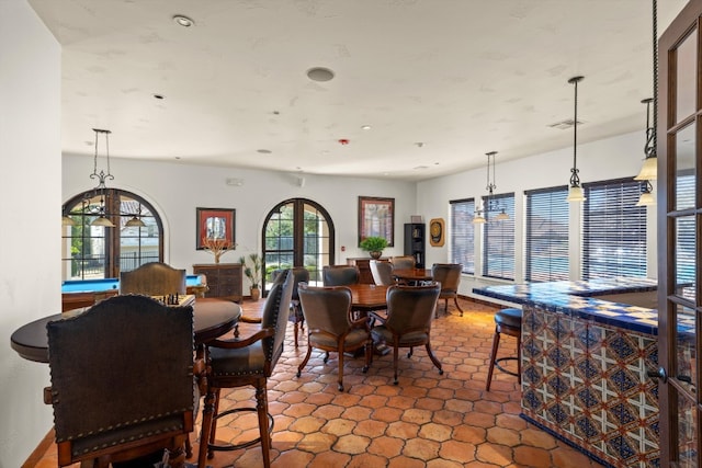 dining space featuring french doors and tile patterned flooring