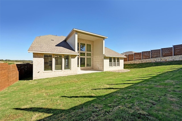 back of property featuring a lawn