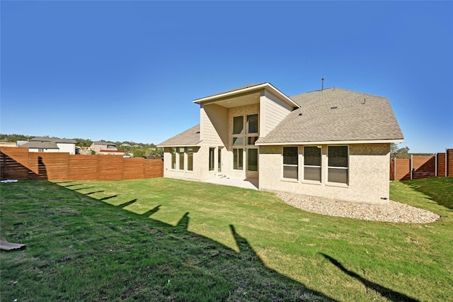 back of property featuring a lawn