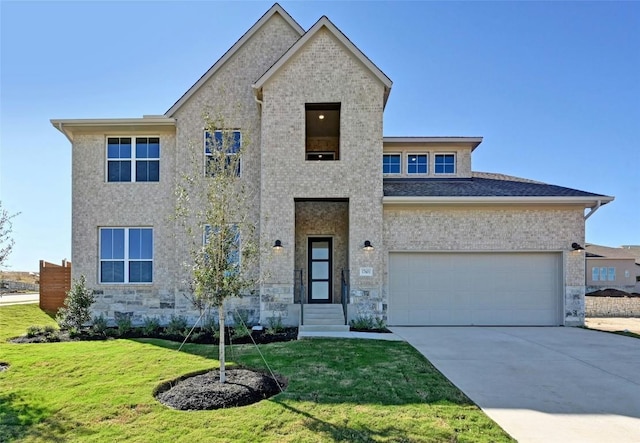 view of front of house with a garage and a front lawn