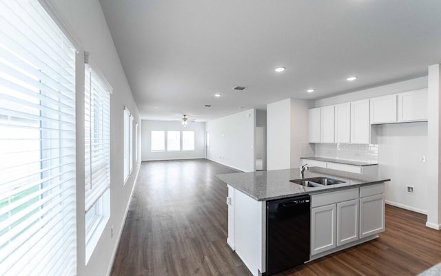 kitchen featuring white cabinetry, sink, an island with sink, and black dishwasher