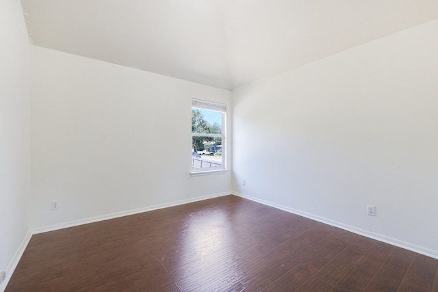 spare room with dark hardwood / wood-style flooring