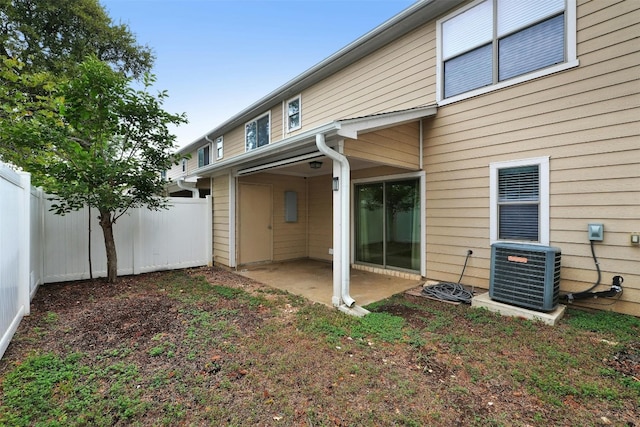 rear view of property featuring a patio and cooling unit