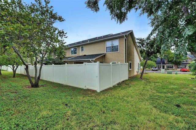 rear view of property featuring a yard