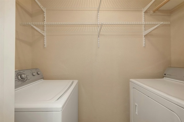 clothes washing area with washer and dryer