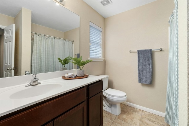 bathroom with vanity, toilet, and tile patterned flooring