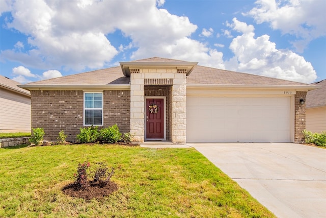 view of front facade with a garage and a front lawn