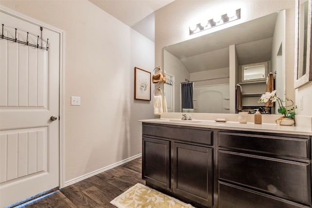 bathroom featuring hardwood / wood-style floors, a shower with shower curtain, and vanity