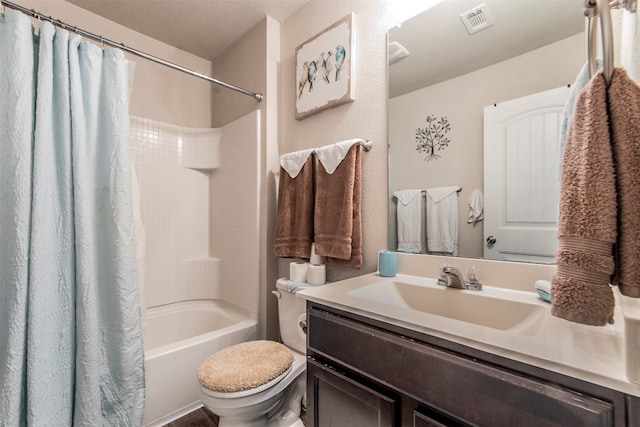 full bathroom featuring a textured ceiling, vanity, toilet, and shower / tub combo with curtain