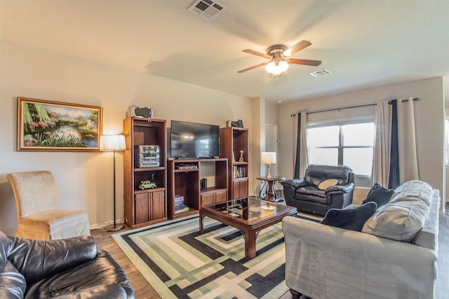 living room with ceiling fan and light hardwood / wood-style floors