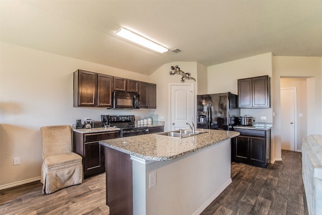 kitchen with sink, black appliances, dark brown cabinets, dark wood-type flooring, and a kitchen island with sink