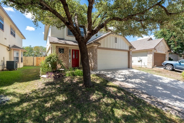 view of front of property featuring central air condition unit, a front yard, and a garage