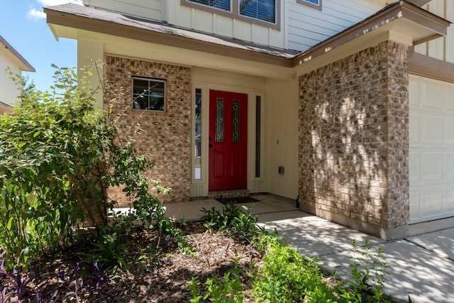 doorway to property with a garage