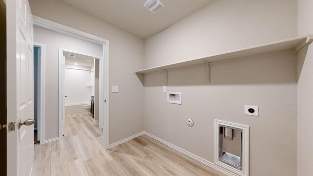 clothes washing area with washer hookup, hookup for a gas dryer, electric dryer hookup, and light hardwood / wood-style flooring