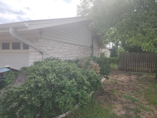 view of side of property with a garage