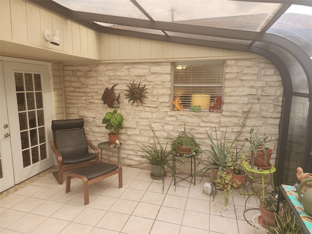 living area featuring vaulted ceiling with beams and light tile patterned flooring