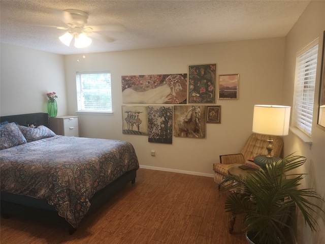 bedroom featuring a textured ceiling, hardwood / wood-style flooring, and ceiling fan