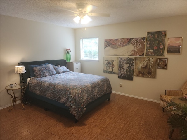 bedroom featuring a textured ceiling, wood-type flooring, and ceiling fan