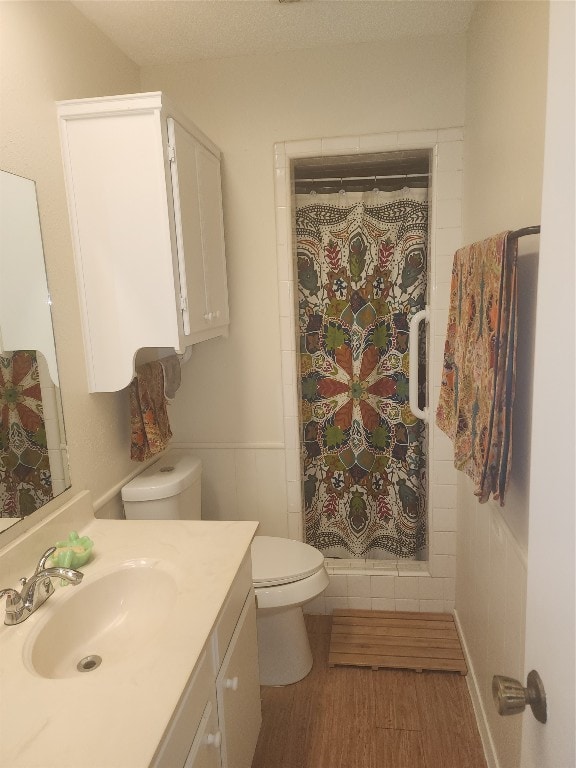 bathroom featuring vanity, hardwood / wood-style floors, a shower with curtain, and toilet