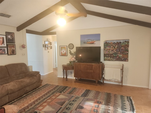 living room with vaulted ceiling with beams and hardwood / wood-style flooring