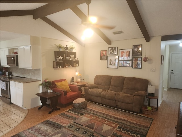 living room with lofted ceiling with beams, light wood-type flooring, and ceiling fan