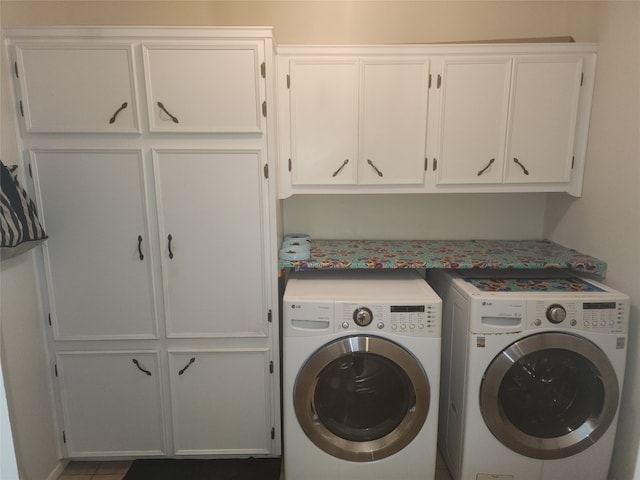 washroom featuring cabinets and separate washer and dryer