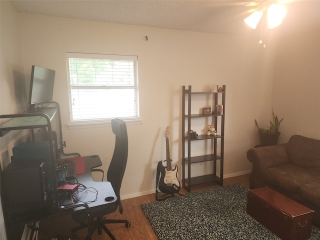 office with ceiling fan, wood-type flooring, and a textured ceiling