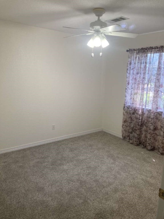 carpeted empty room featuring ceiling fan