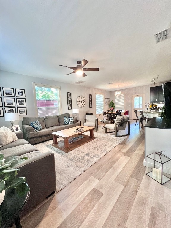 living room featuring light hardwood / wood-style floors and ceiling fan