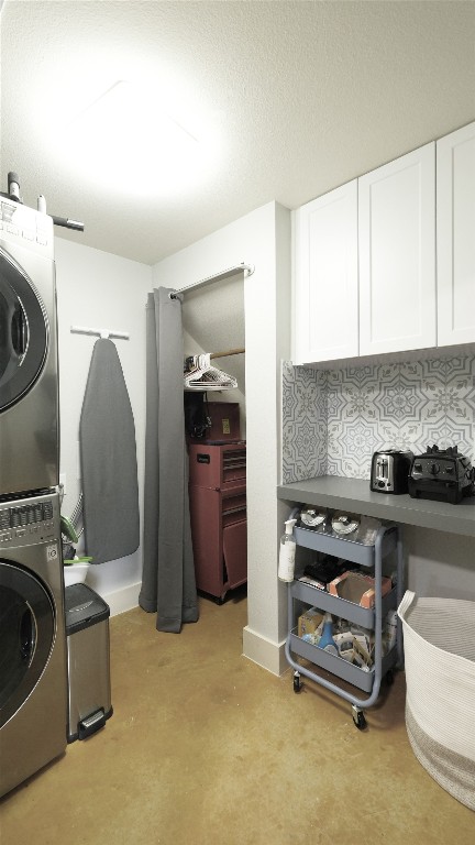 laundry area with stacked washer and dryer