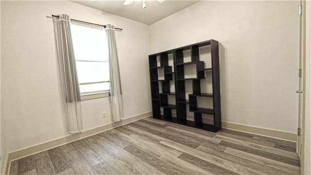 spare room featuring ceiling fan and hardwood / wood-style floors