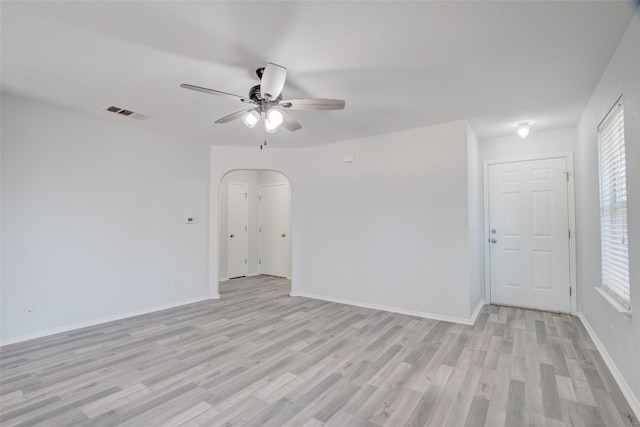 empty room with ceiling fan and light hardwood / wood-style floors