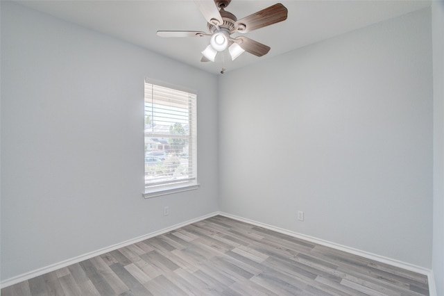 spare room featuring light wood-type flooring and ceiling fan