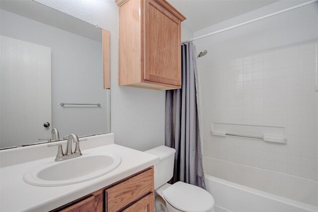 full bathroom with vanity, toilet, and shower / tub combo with curtain